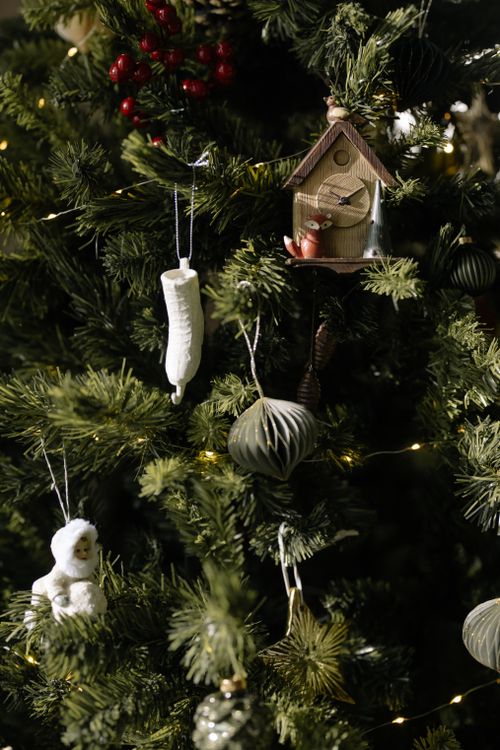 Free Close-up of a decorated Christmas tree with lights and delicate ornaments, creating a festive atmosphere. Stock Photo