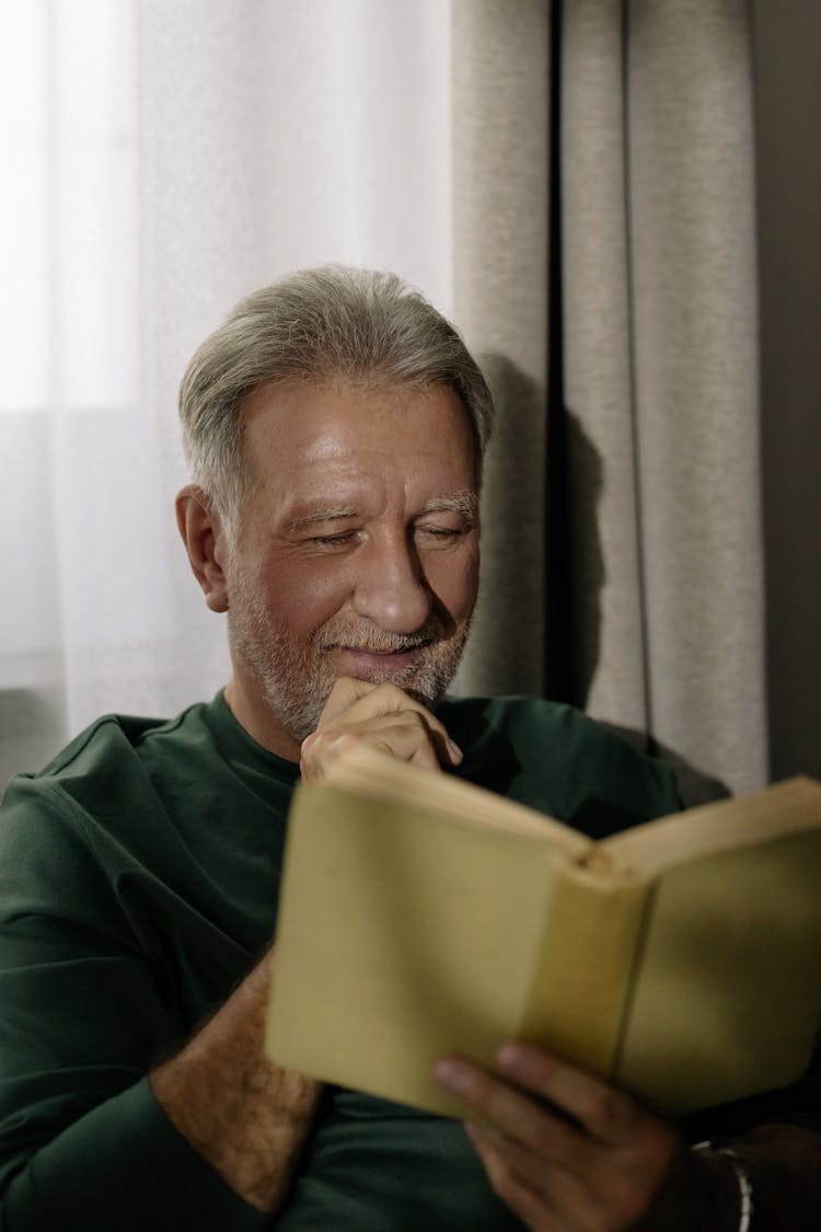 Elderly Man Reading A Book