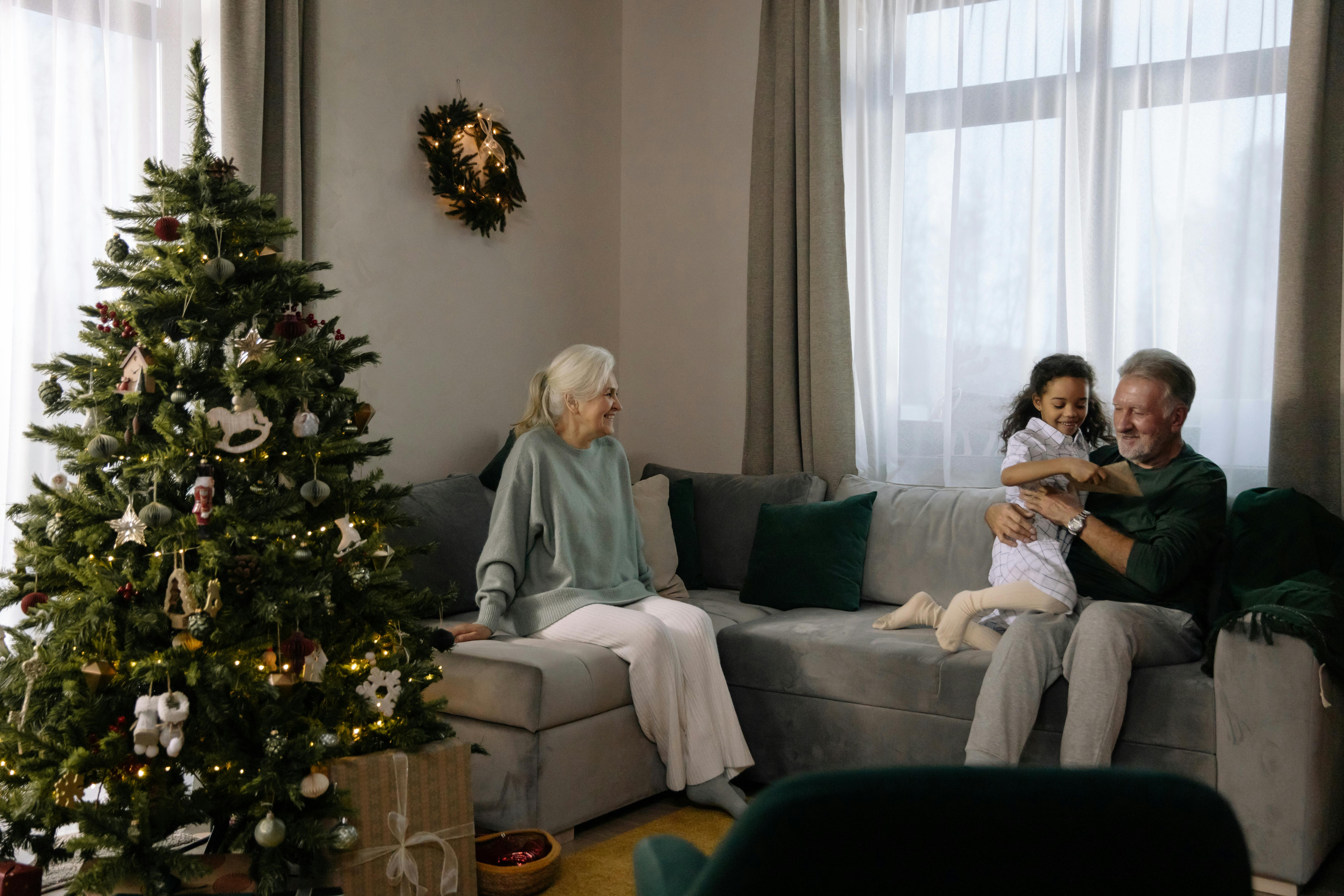 woman in gray sweater sitting on gray couch