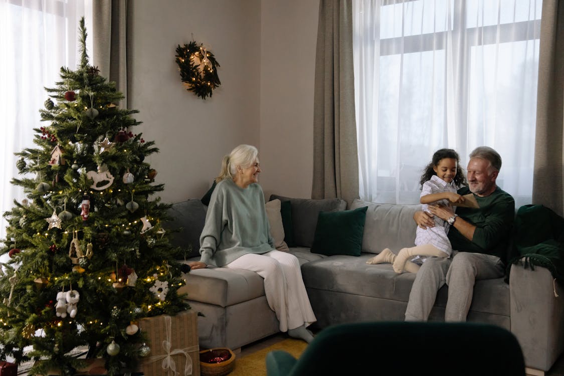 Woman in Gray Sweater Sitting on Gray Couch