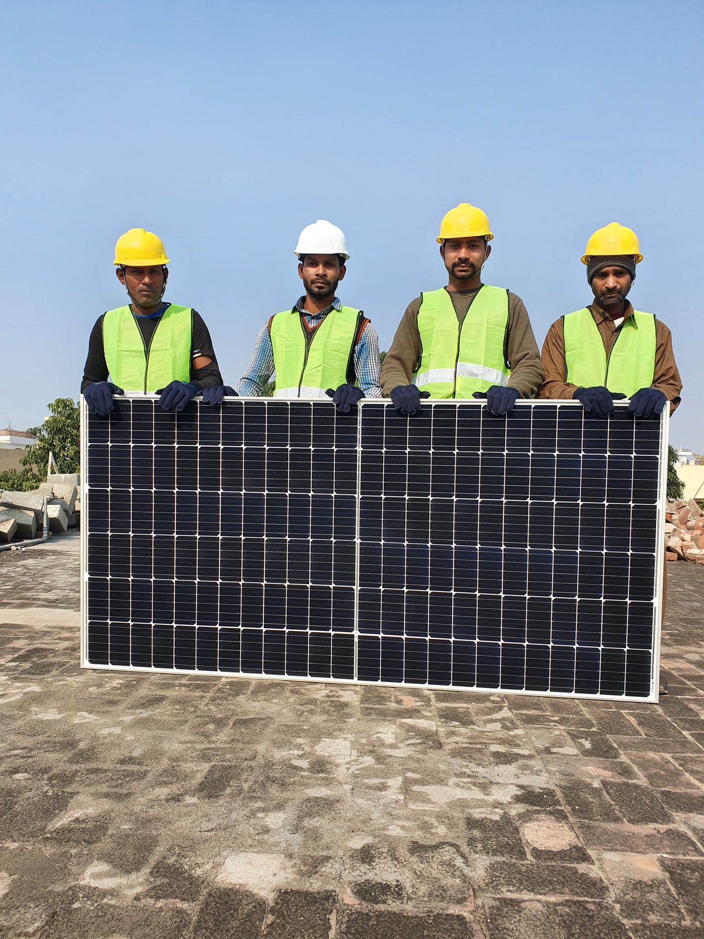 Installation crew holding a rooftop solar panel