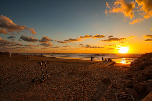 Free Silhouette of People on Beach during Sunset Stock Photo