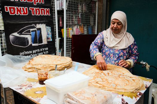 Woman Preparing Iranian Bread on a Street Food Market 