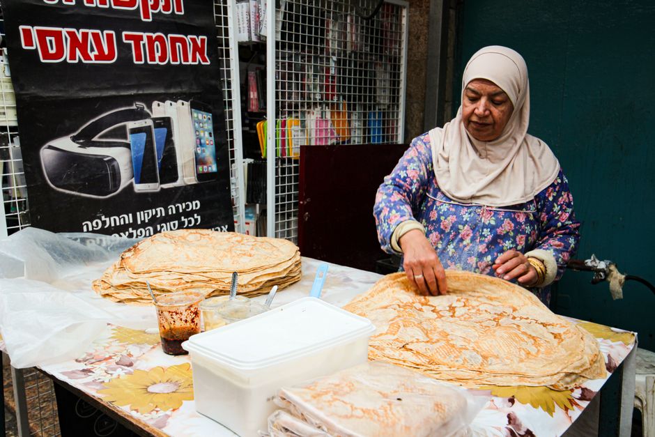 Bustling Shuk Hacarmel market in Tel Aviv with vendors and shoppers