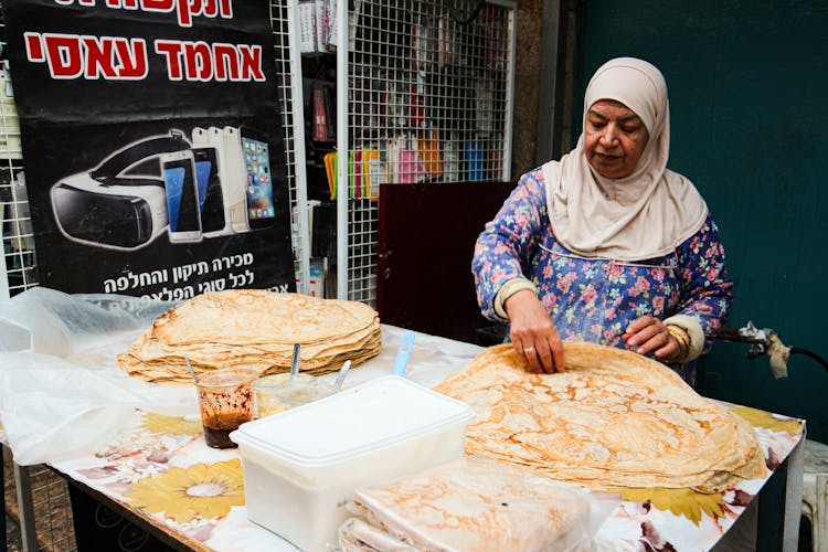 Woman Preparing Iranian Bread On A Street Food Market 