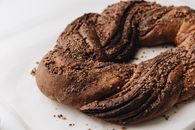 A close-up of a freshly baked chocolate babka with a rich and textured surface.