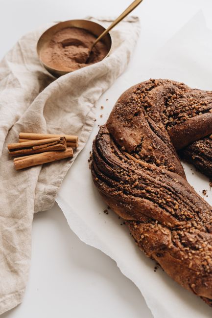 Delicious freshly baked rustic strudel topped with cinnamon and crumble on a wooden table.