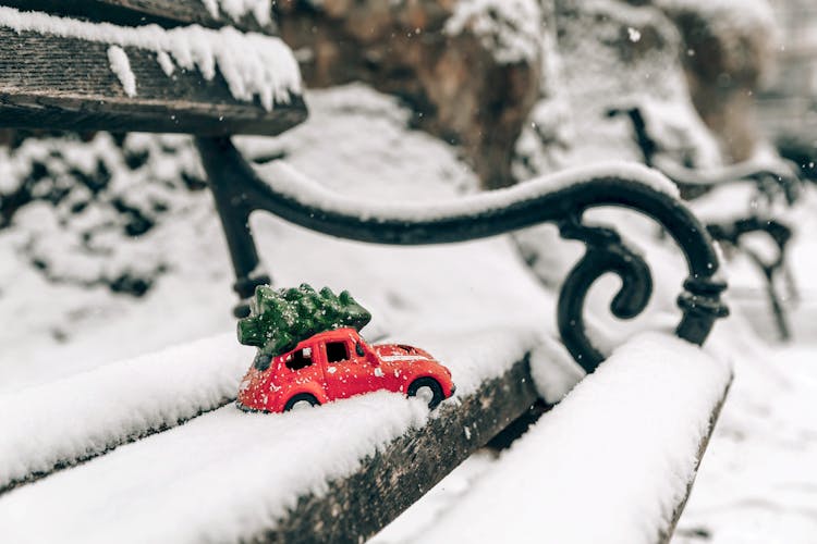 A Red Beetle Car With Christmas Tree On Top