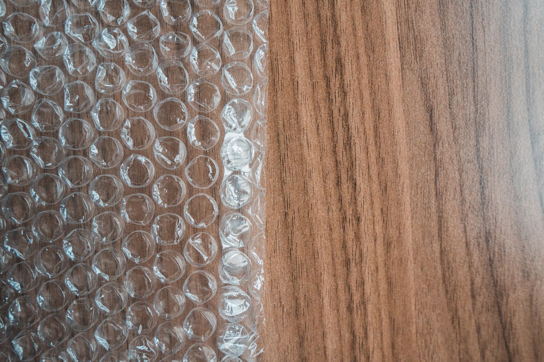 protective packaging materials including bubble wrap, air pillows, and corrugated cardboard boxes on a packing station