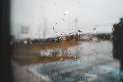 Free Transparent glass wall with aqua drips and wavy flows on rainy day on blurred background Stock Photo