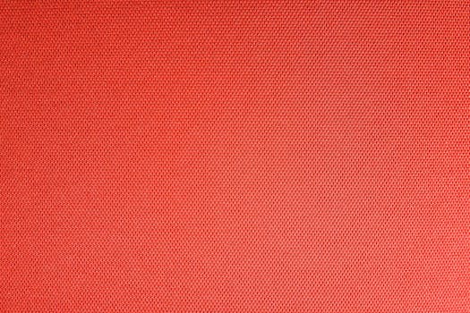 Detailed texture of a vibrant red woven textile fabric, perfect for backgrounds.