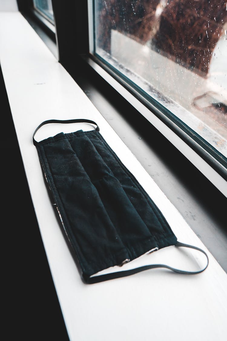 Black Fabric Mask On Windowsill In Building