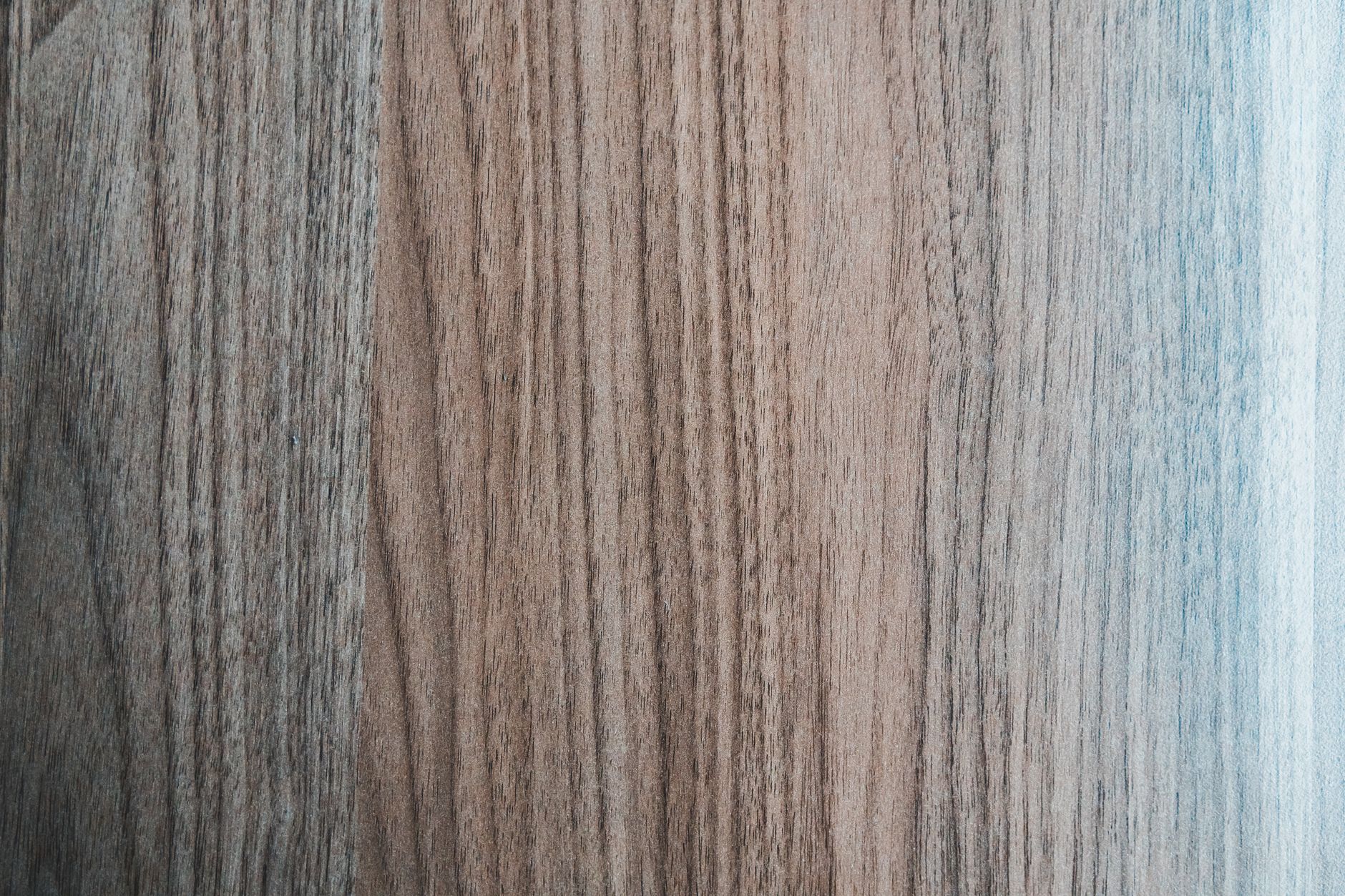 Overhead view of textured backdrop representing wooden desk.
