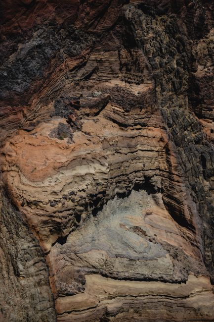 Vertical shot of layered rock formations showcasing geological textures in Madeirã, Portugal.