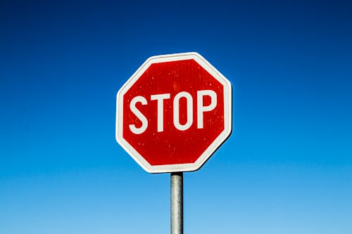 Red Stop Road Sign Under Blue Sky