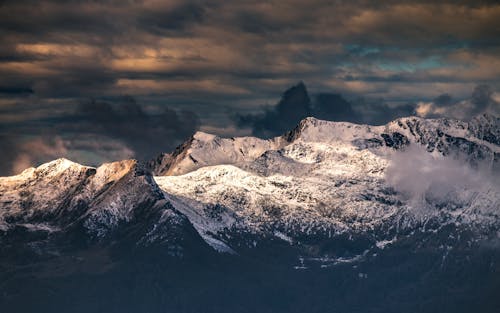 Snow Covered Mountain Under Dark Clouds