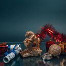 Shiny golden bull figurine and bauble arranged with money during New Year holiday
