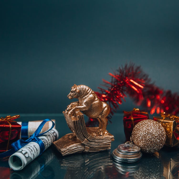 Shiny Golden Bull Figurine And Bauble Arranged With Money During New Year Holiday