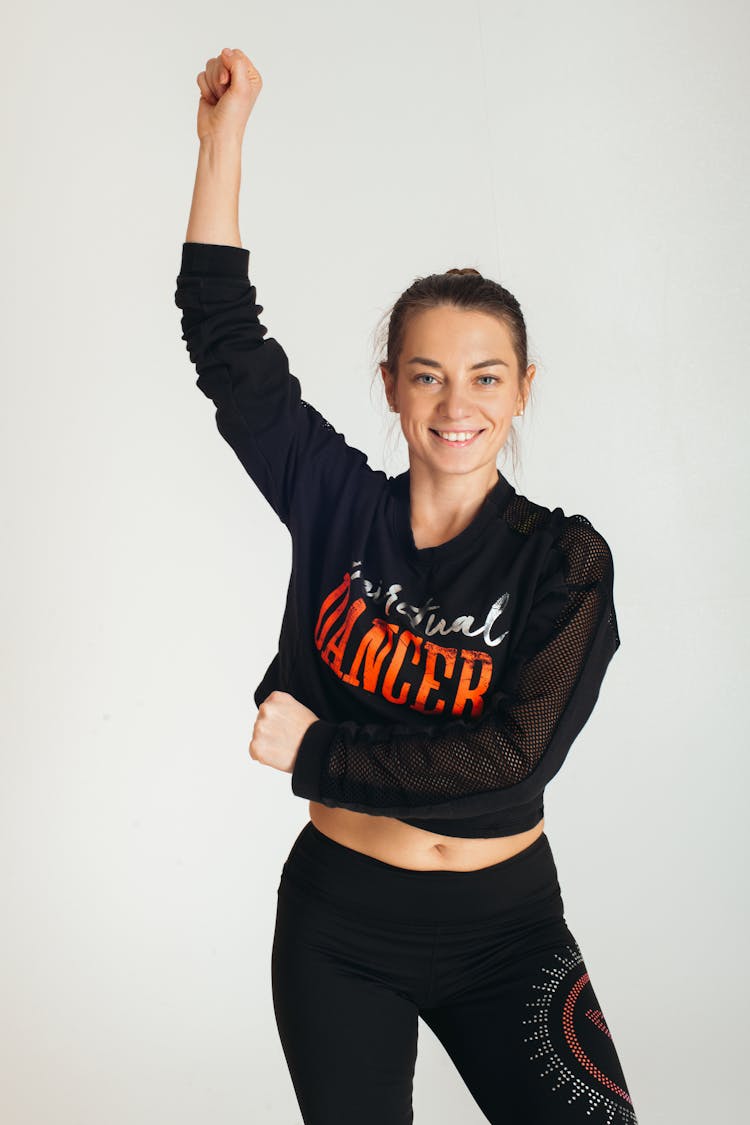 Woman In Sports Clothing With A Raised Fist 