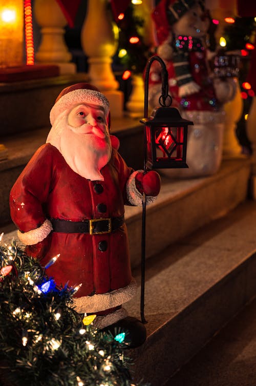 Santa Claus Figurine Holding Lamp Post