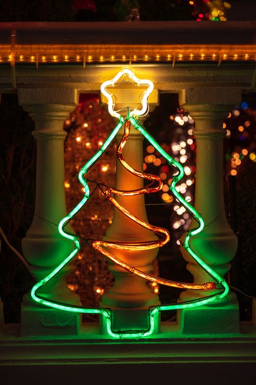 Free Glowing neon tree with star, perfect for holiday decoration inspiration. Stock Photo