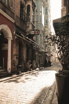 Explore the timeless beauty of a cobblestone street in Istanbul's historic area, captured in warm tones.