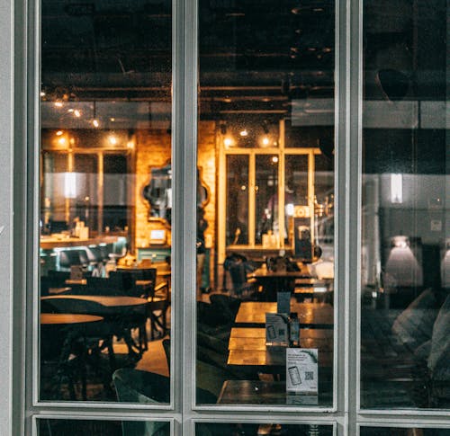 Through glass wall stylish empty restaurant interior