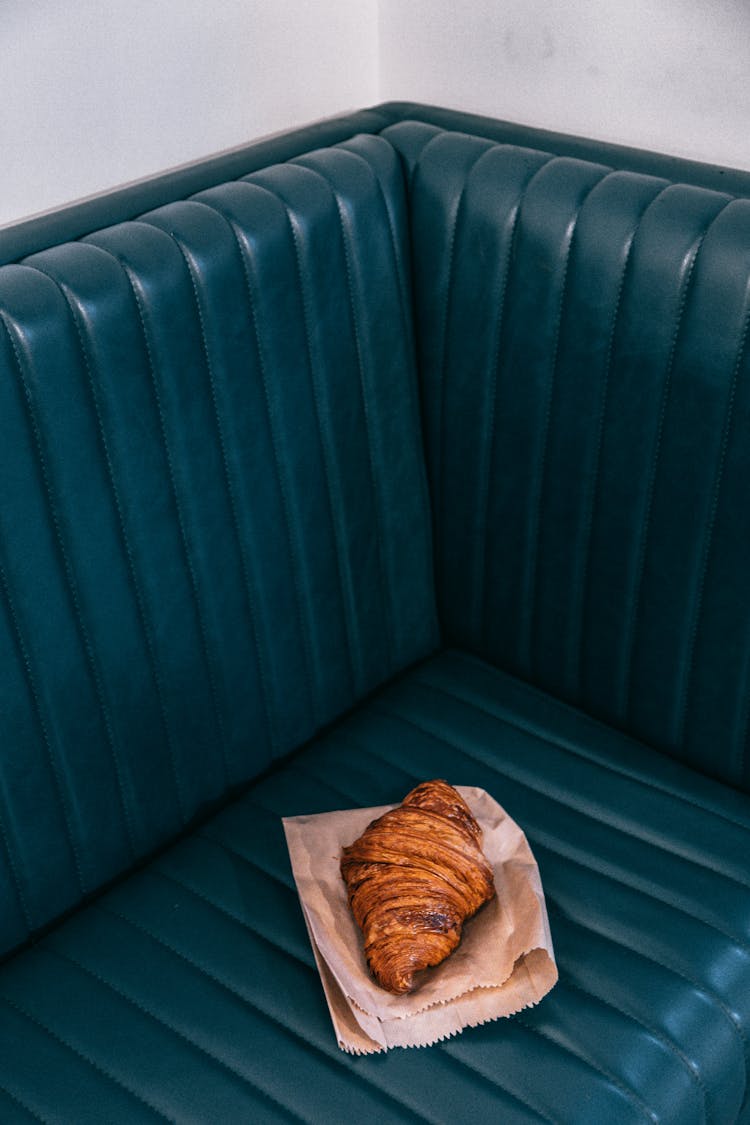 Croissant On Paper Placed On Sofa