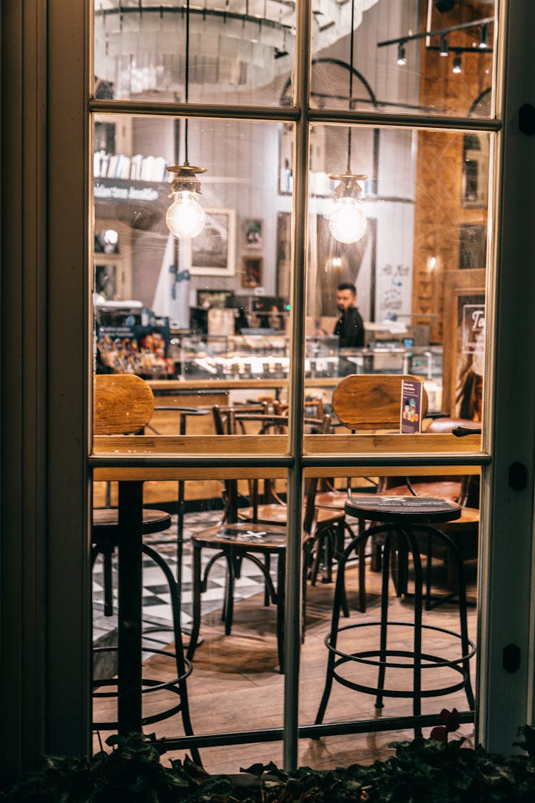 Stylish Restaurant With Tables And Chairs Under Shining Lamps