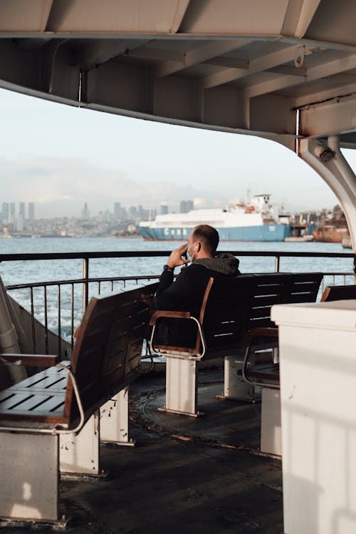 Passenger resting on deck of ship in sunny day