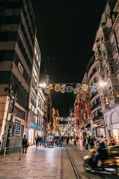 Free From below of crowded street between residential buildings decorated for Christmas at night Stock Photo