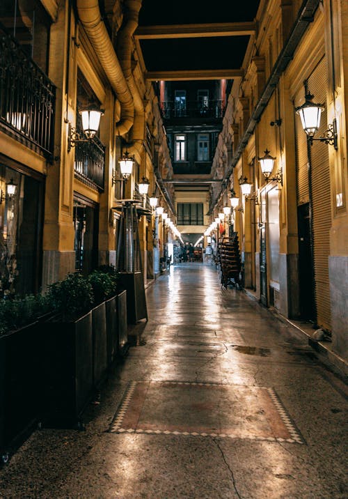 Narrow street with lamps at night