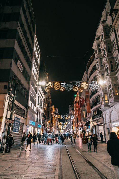 Free Low angle of crowded street between residential houses decorated for Christmas at night Stock Photo