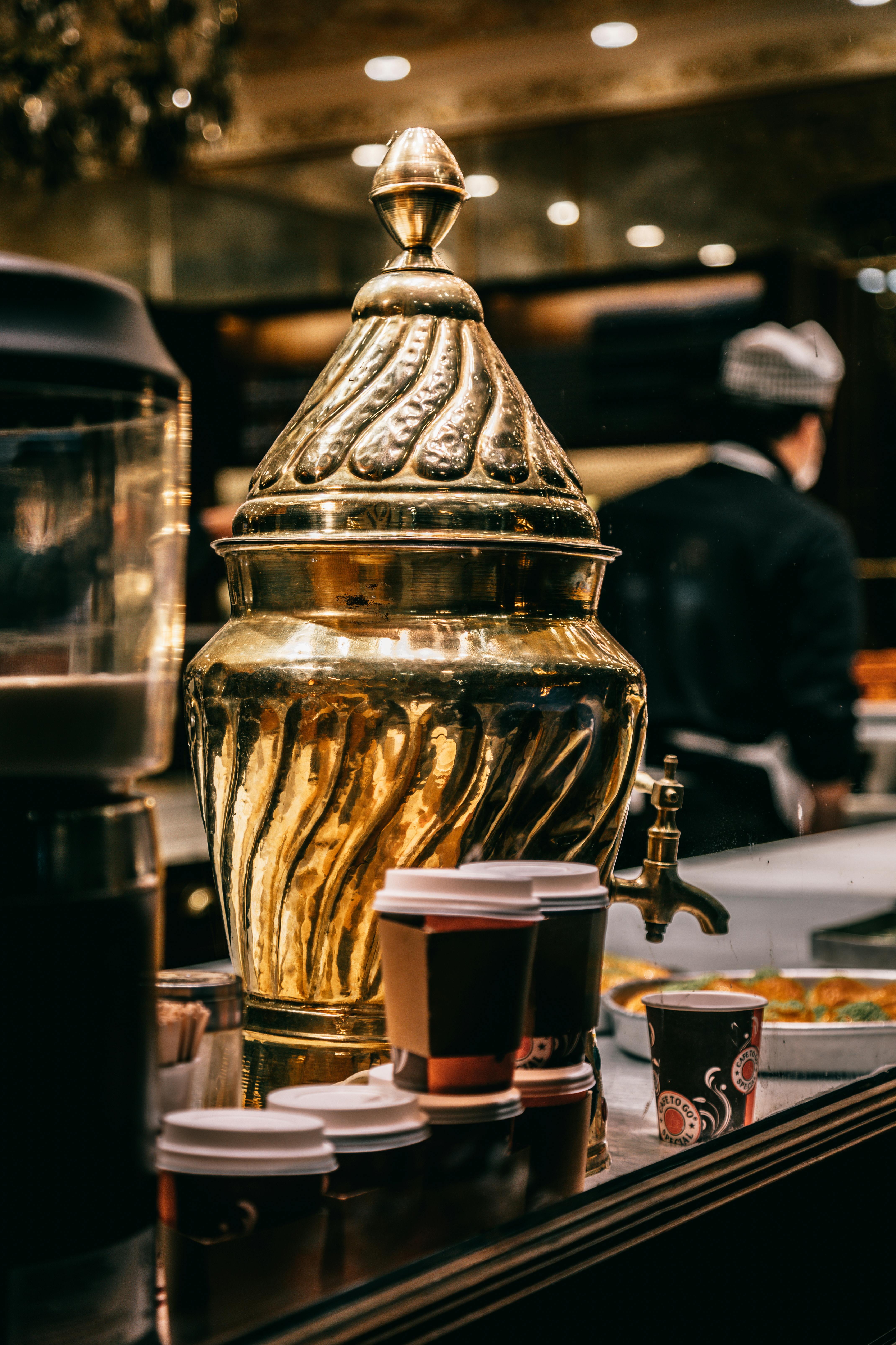 samovar and paper cups on counter