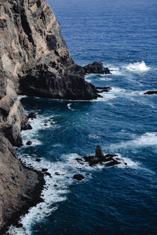 Waves Crashing on Rocky Shore of Mountain