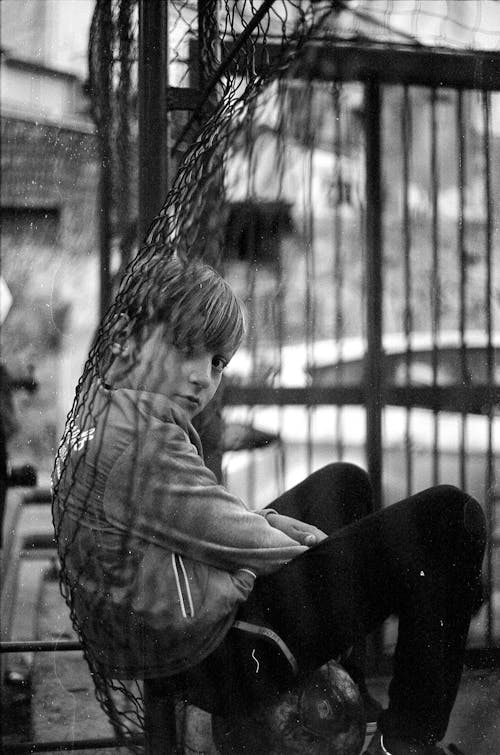 Free Grayscale Photo of Boy Sitting  Stock Photo