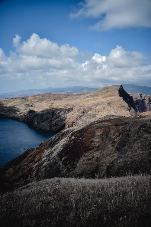 Free Stunning view of cliffs and ocean under a cloudy sky in Madeira, Portugal. Ideal for nature and travel photography. Stock Photo