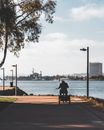Person in Three Wheeler Bike on Walkway