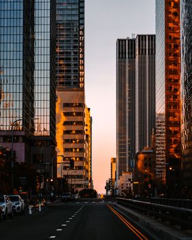 Stunning Los Angeles cityscape at sunset showcasing modern skyscrapers and dramatic reflections.