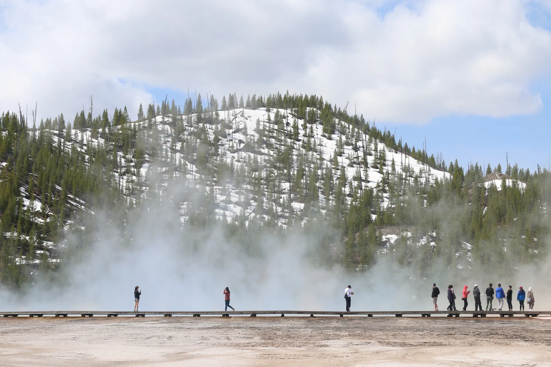 Boardwalk running past a steaming thermal pool in Yellowstone National Park Boardwalk running past a steaming thermal pool in Yellowstone National Park