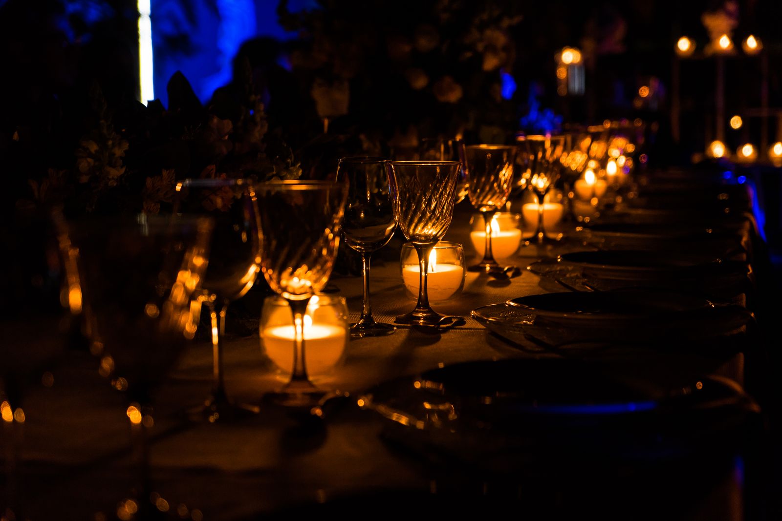 A candlelit dinner table set for an evening gathering