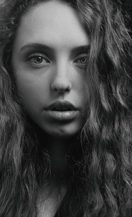 Grayscale Photo of Woman with Curly Hair · Free Stock Photo