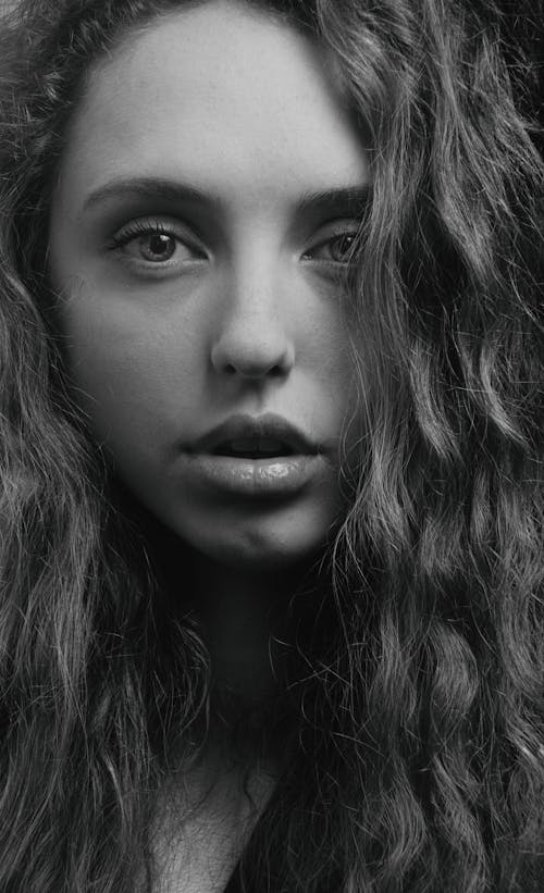 Grayscale Photo of Woman with Curly Hair