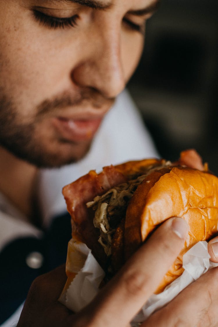 A Man Eating Hamburger