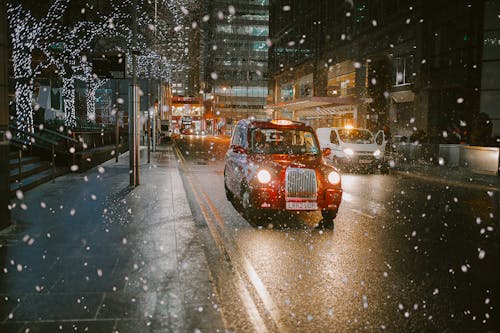 Free A Red Taxi on Road during Nighttime Stock Photo