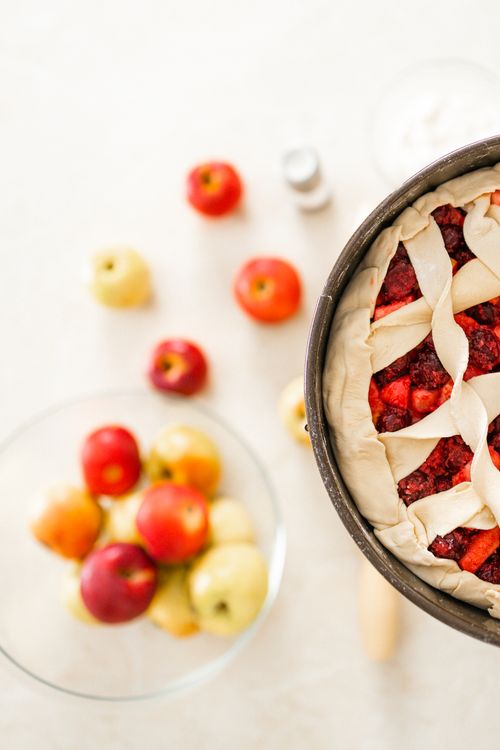 Free Homemade unbaked fruit pie with apples on a kitchen counter, ready for baking. Stock Photo
