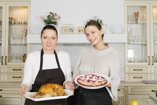 A mother and daughter enjoy quality time cooking together in the kitchen.