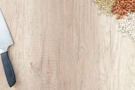 木制表面质朴，上面放着刀和各种烹饪用的豆子