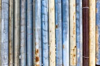 Wall with various thick shabby pipes