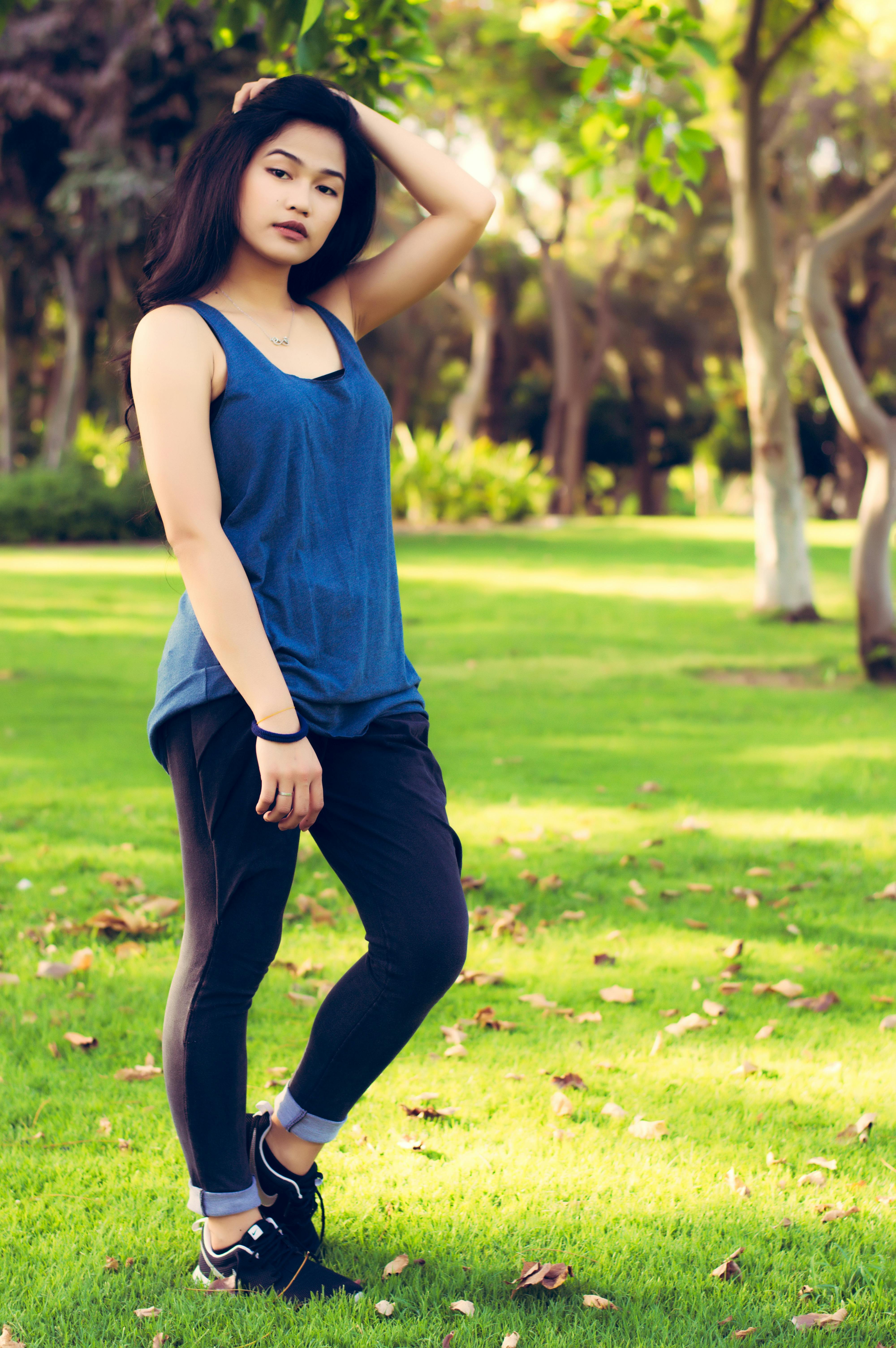 Full body shot of young beautiful Indian woman posing with one l